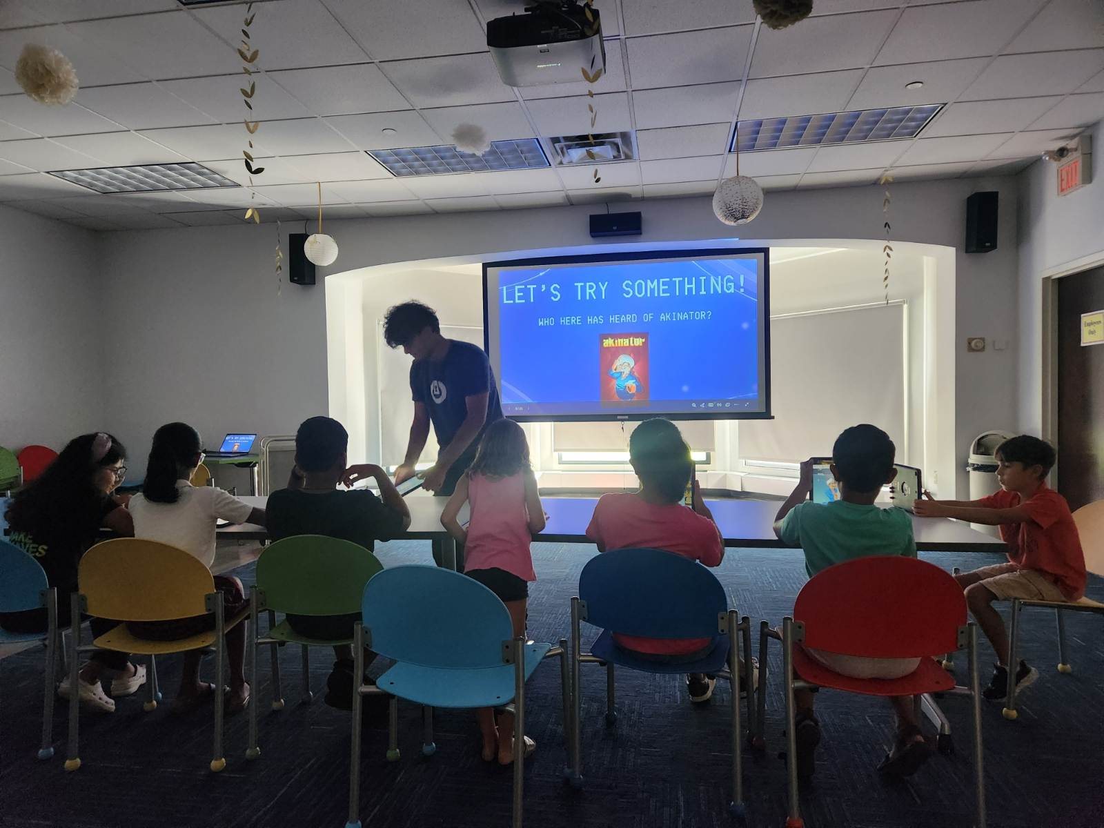 Children at a TheLearnAI Program lesson trying an AI guessing game