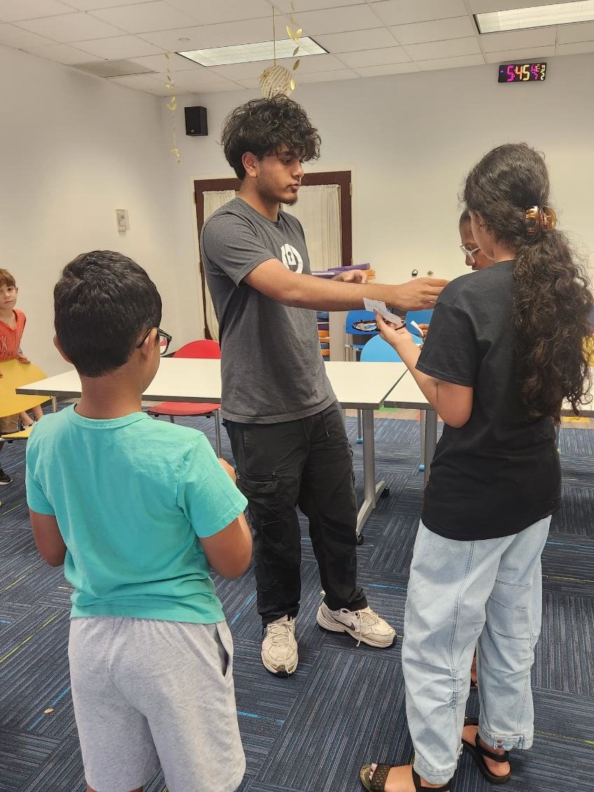 A teacher handing out lesson cards to students