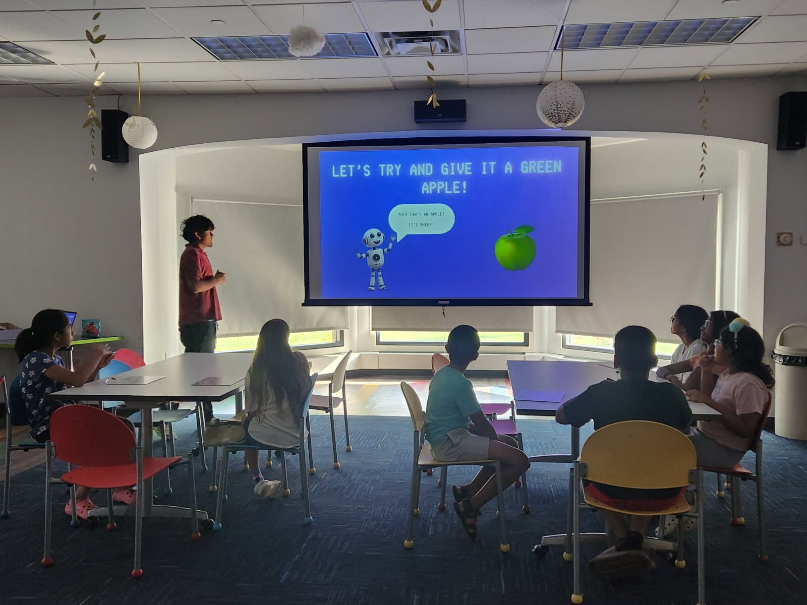 Students discussing an AI lesson about a green apple